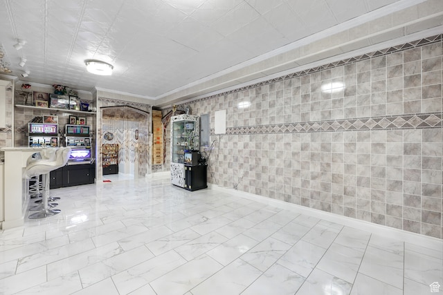 interior space featuring marble finish floor and tile walls