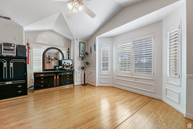 interior space featuring a healthy amount of sunlight, lofted ceiling, a ceiling fan, and visible vents