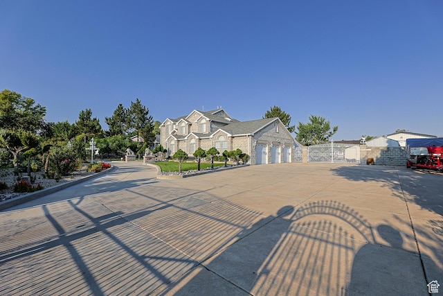 view of front facade with a residential view, a gate, driveway, a garage, and fence