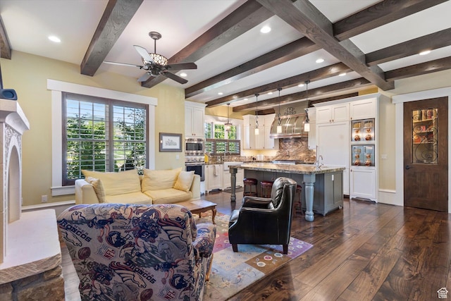 living area featuring a ceiling fan, recessed lighting, beam ceiling, and dark wood finished floors