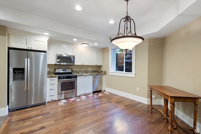 kitchen featuring baseboards, recessed lighting, appliances with stainless steel finishes, white cabinetry, and dark wood-style floors