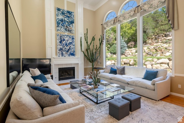 3880 E Thousand Oaks Cir, Salt Lake City, UT 84124 - living room featuring crown molding, wood finished floors, baseboards, and a tile fireplace