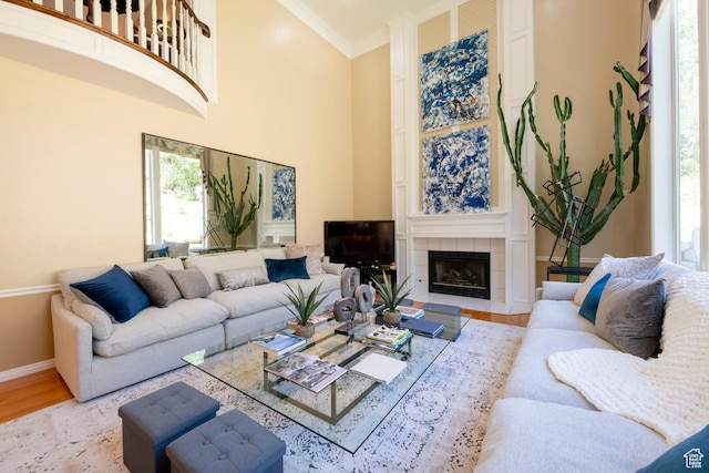 3880 E Thousand Oaks Cir, Salt Lake City, UT 84124 - living room with light wood finished floors, baseboards, ornamental molding, a fireplace, and a towering ceiling