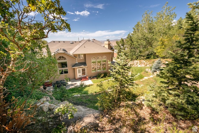 3880 E Thousand Oaks Cir, Salt Lake City, UT 84124 - view of front of property with stucco siding, a chimney, a front lawn, and a patio area