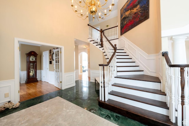 3880 E Thousand Oaks Cir, Salt Lake City, UT 84124 - foyer featuring stairs, a decorative wall, arched walkways, and marble finish floor