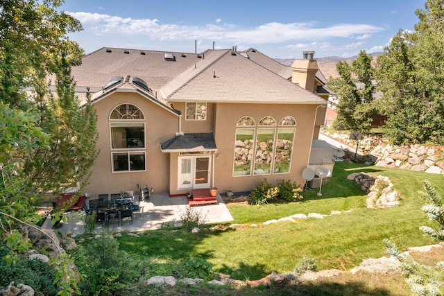 3880 E Thousand Oaks Cir, Salt Lake City, UT 84124 - rear view of house with a patio, a yard, a chimney, and stucco siding