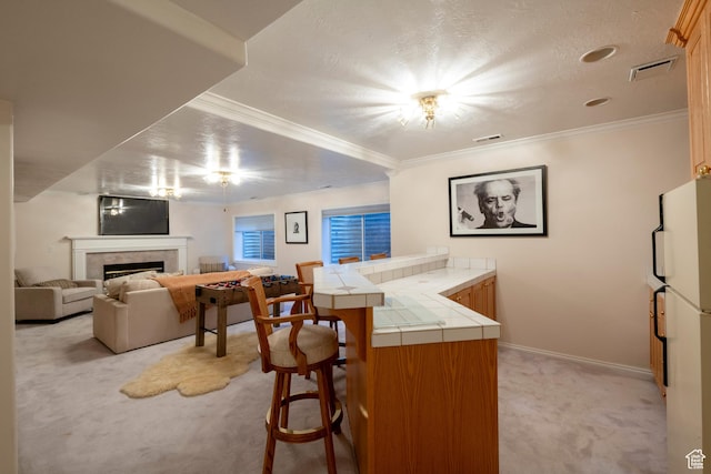 3880 E Thousand Oaks Cir, Salt Lake City, UT 84124 - kitchen featuring visible vents, tile countertops, light colored carpet, a peninsula, and freestanding refrigerator