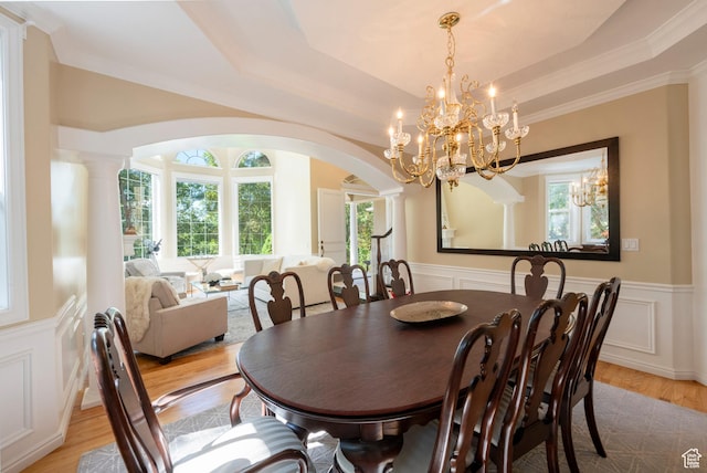 3880 E Thousand Oaks Cir, Salt Lake City, UT 84124 - dining area with a chandelier, a wainscoted wall, light wood-type flooring, a tray ceiling, and arched walkways