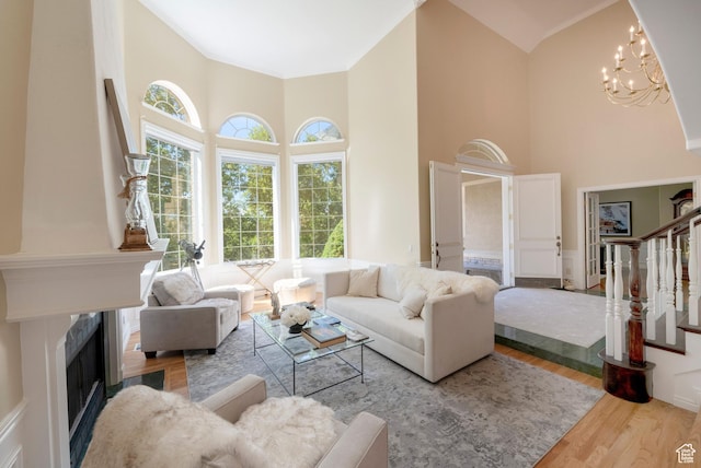 3880 E Thousand Oaks Cir, Salt Lake City, UT 84124 - living area featuring stairs, a high end fireplace, wood finished floors, and a towering ceiling
