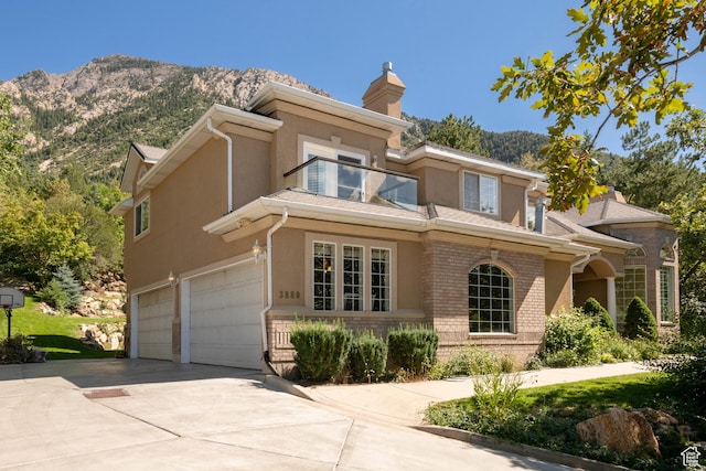 3880 E Thousand Oaks Cir, Salt Lake City, UT 84124 - view of front of home featuring a garage, a mountain view, driveway, and stucco siding