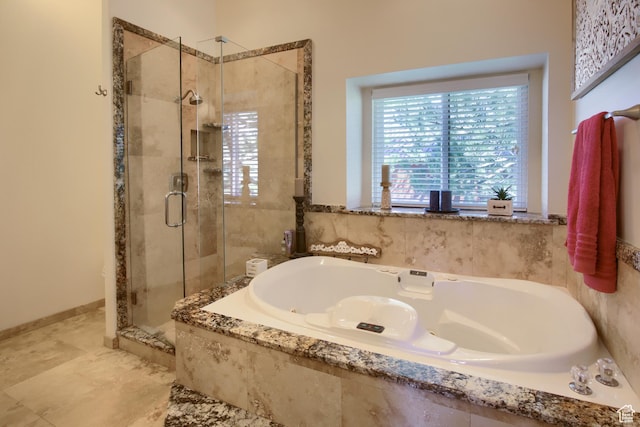 bathroom featuring a bath and a shower stall