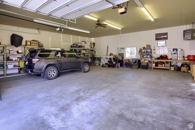 garage with a garage door opener and a workshop area