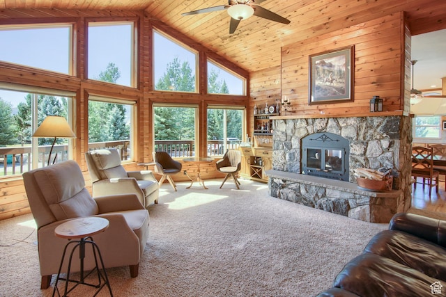 living room with a healthy amount of sunlight, a fireplace, carpet floors, and a ceiling fan