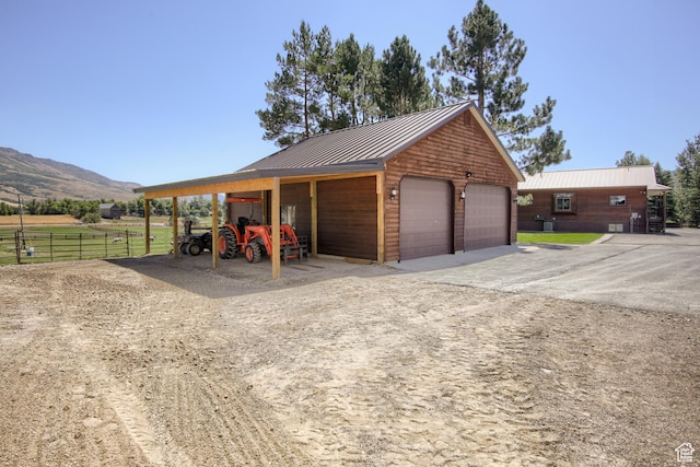 garage featuring a detached garage and a mountain view