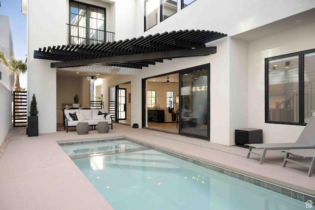 back of house with a patio, outdoor lounge area, stairway, a pergola, and stucco siding