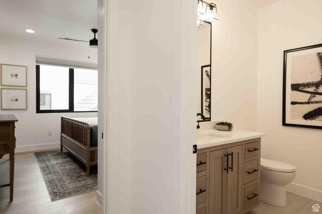 5346 Cyan Ln, St George, UT 84790 - bathroom with toilet, baseboards, wood finished floors, and vanity