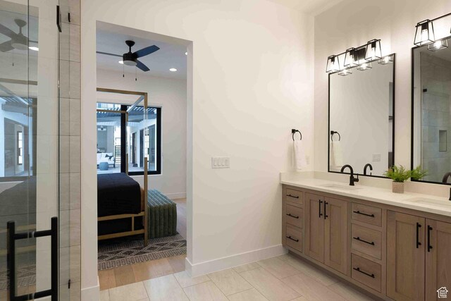 5346 Cyan Ln, St George, UT 84790 - ensuite bathroom featuring ceiling fan, double vanity, a sink, and connected bathroom