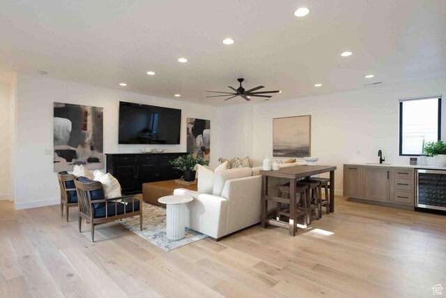 5346 Cyan Ln, St George, UT 84790 - living area with wine cooler, indoor wet bar, light wood-style flooring, and recessed lighting
