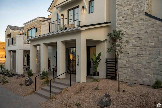 5346 Cyan Ln, St George, UT 84790 - view of exterior entry featuring a balcony and stucco siding