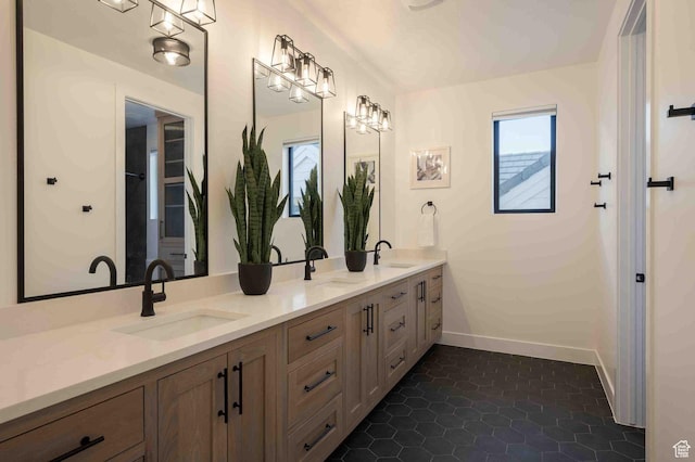 5346 Cyan Ln, St George, UT 84790 - bathroom with double vanity, tile patterned flooring, baseboards, and a sink