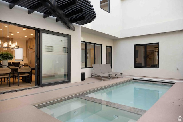 5346 Cyan Ln, St George, UT 84790 - interior space with a pool with connected hot tub and an inviting chandelier