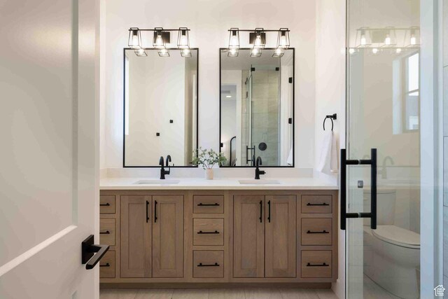 5346 Cyan Ln, St George, UT 84790 - bathroom with toilet, a stall shower, double vanity, and a sink