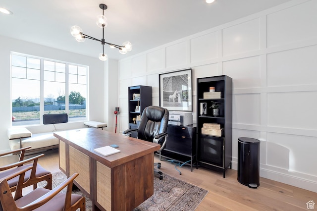 165 S Farmhouse Cir, Kaysville, UT 84037 - home office featuring light wood-type flooring, a decorative wall, and a notable chandelier