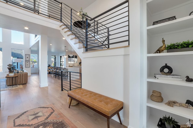 165 S Farmhouse Cir, Kaysville, UT 84037 - hallway featuring built in shelves, baseboards, a high ceiling, and wood finished floors