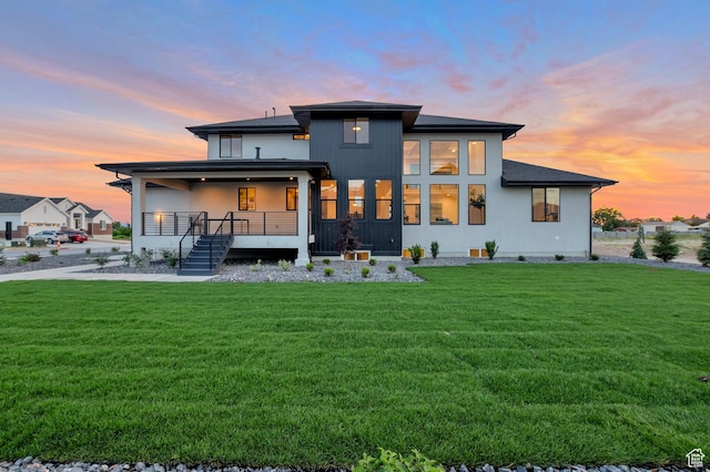 165 S Farmhouse Cir, Kaysville, UT 84037 - back of house at dusk featuring a lawn