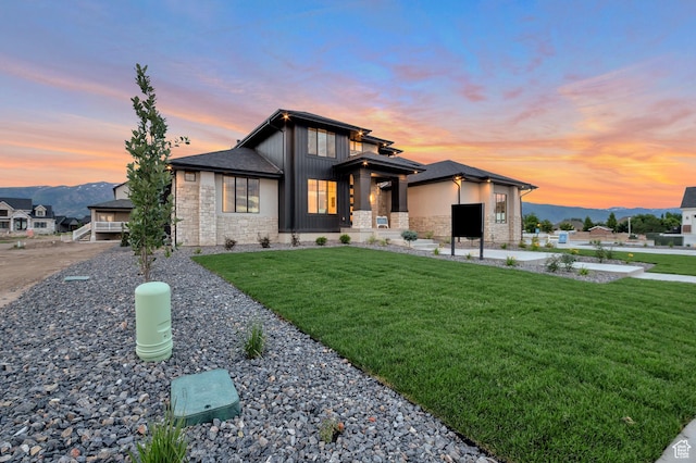 165 S Farmhouse Cir, Kaysville, UT 84037 - view of front facade with stone siding, a front lawn, board and batten siding, and a mountain view
