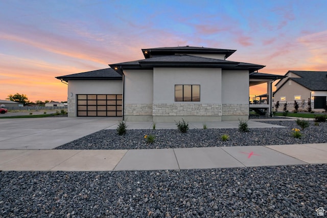 165 S Farmhouse Cir, Kaysville, UT 84037 - view of side of home featuring a garage, stone siding, concrete driveway, and stucco siding