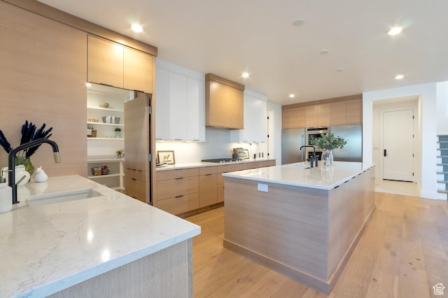 165 S Farmhouse Cir, Kaysville, UT 84037 - kitchen with modern cabinets, premium range hood, light wood-style floors, gas stovetop, and a sink