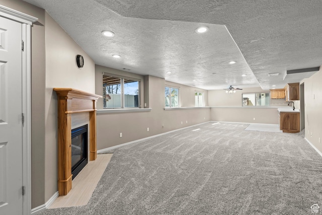 880 E 300 S, Smithfield, UT 84335 - unfurnished living room with baseboards, a textured ceiling, and a glass covered fireplace