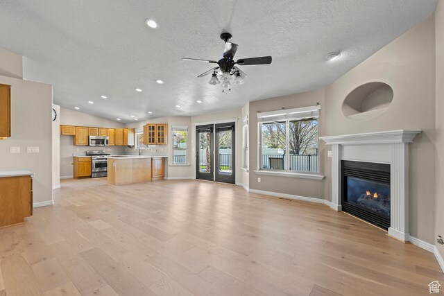 880 E 300 S, Smithfield, UT 84335 - unfurnished living room with baseboards, recessed lighting, light wood-type flooring, a textured ceiling, and a ceiling fan