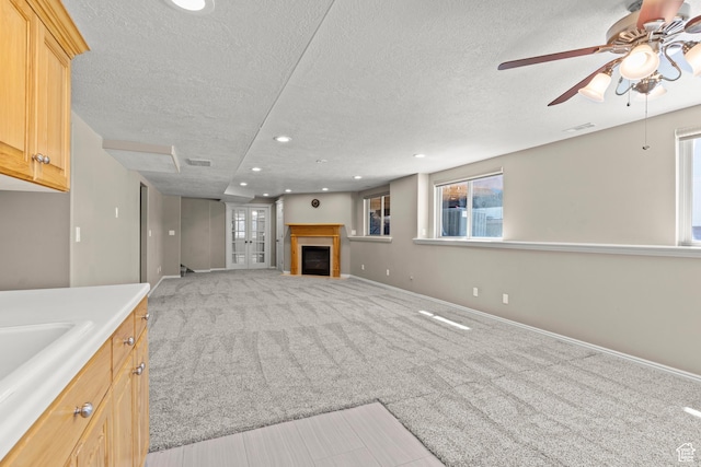 880 E 300 S, Smithfield, UT 84335 - unfurnished living room with ceiling fan, light carpet, a fireplace, a textured ceiling, and recessed lighting