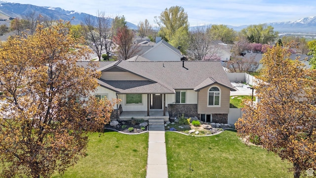 880 E 300 S, Smithfield, UT 84335 - view of front of home featuring fence, a shingled roof, a mountain view, and a front yard