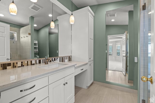 880 E 300 S, Smithfield, UT 84335 - bathroom featuring recessed lighting, visible vents, a tile shower, and vanity