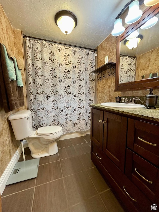 221 N 100 E, Price, UT 84501 - full bathroom featuring toilet, vanity, baseboards, tile patterned floors, and a textured ceiling