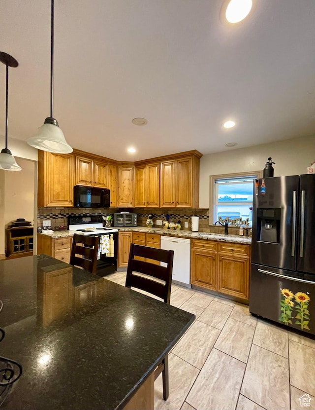 221 N 100 E, Price, UT 84501 - kitchen with electric stove, stainless steel refrigerator with ice dispenser, white dishwasher, black microwave, and a sink