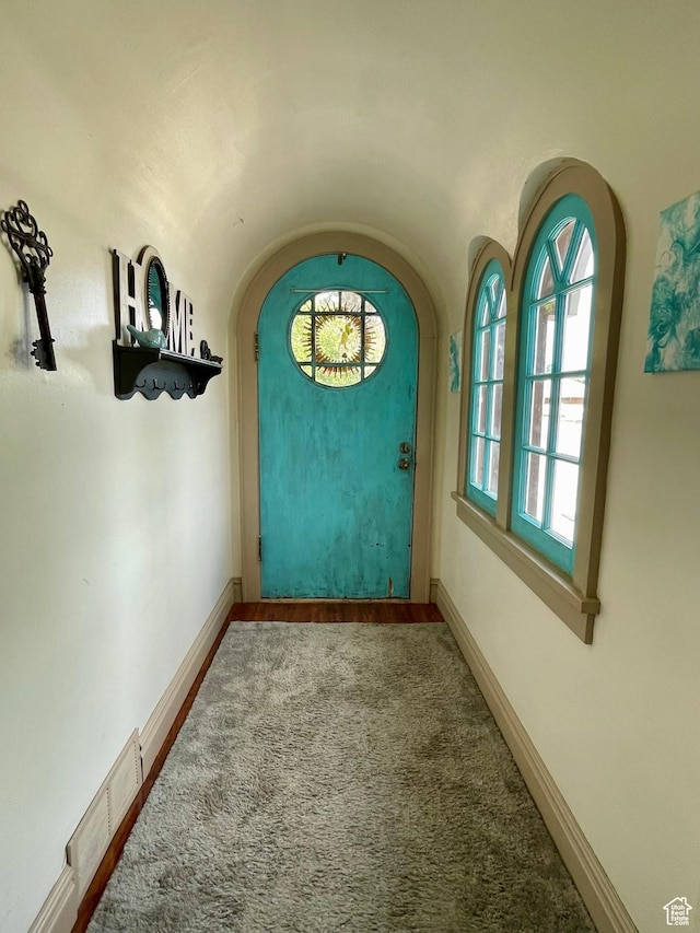 221 N 100 E, Price, UT 84501 - doorway with arched walkways, baseboards, vaulted ceiling, and carpet