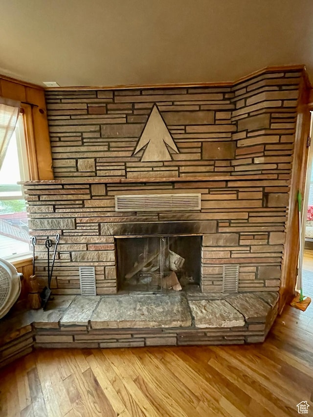 221 N 100 E, Price, UT 84501 - detailed view of wood finished floors and a stone fireplace
