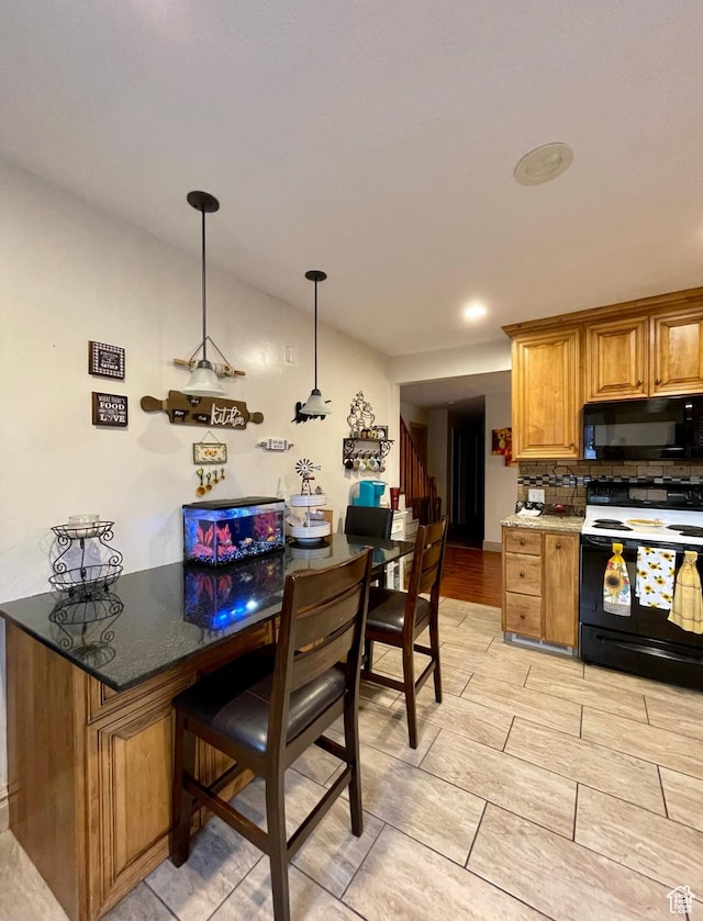221 N 100 E, Price, UT 84501 - kitchen with black microwave, range with electric cooktop, brown cabinets, a breakfast bar area, and pendant lighting