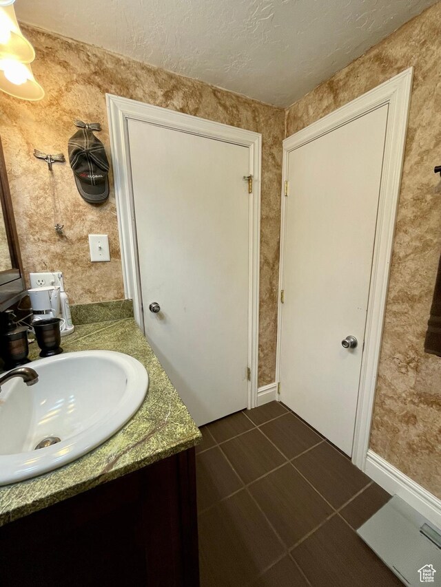 221 N 100 E, Price, UT 84501 - bathroom with vanity, tile patterned floors, and a textured ceiling