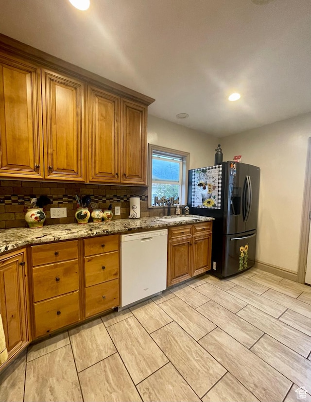 221 N 100 E, Price, UT 84501 - kitchen featuring dishwasher, refrigerator with ice dispenser, brown cabinetry, tasteful backsplash, and recessed lighting