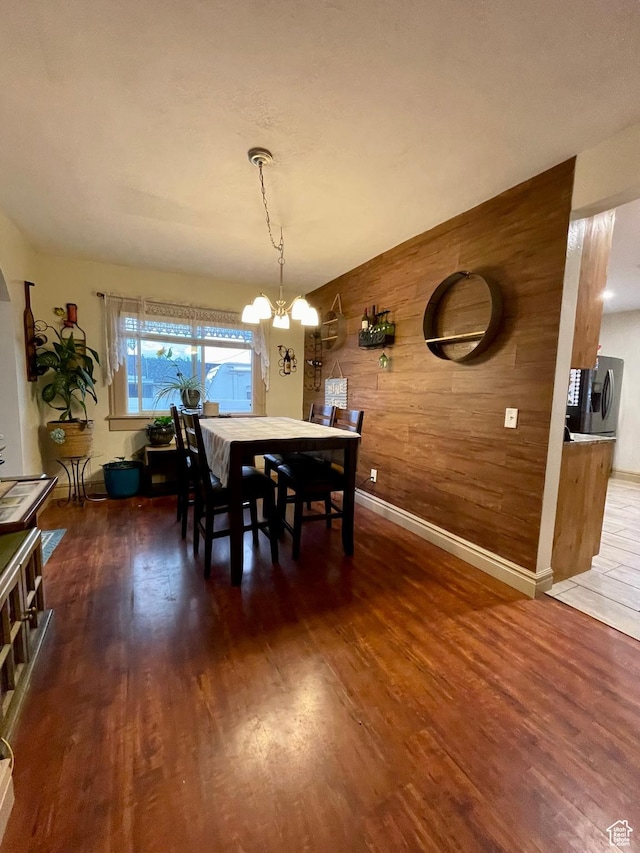 221 N 100 E, Price, UT 84501 - dining area with wooden walls, wood finished floors, a chandelier, and baseboards