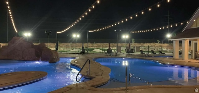1240 E Villa Way Unit 64, Washington, UT 84780 - pool at twilight with a patio, fence, and a community pool