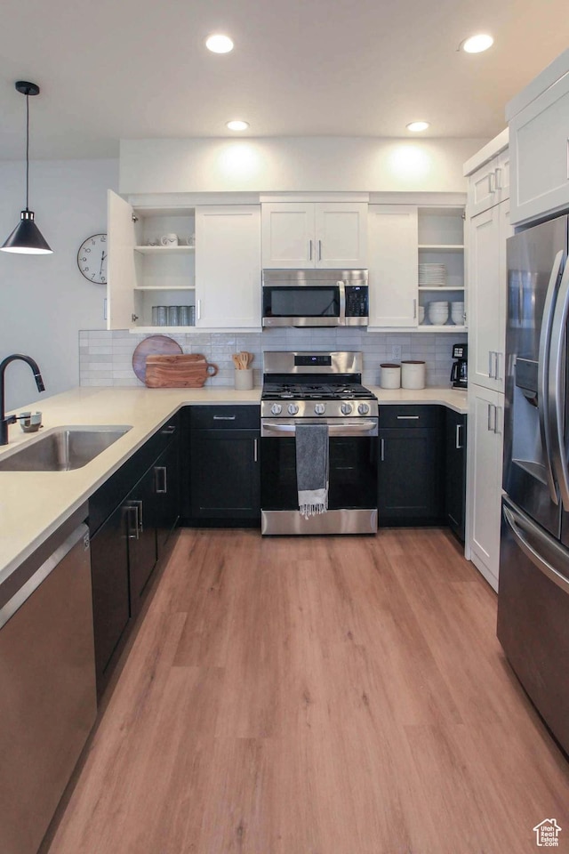 1240 E Villa Way Unit 64, Washington, UT 84780 - kitchen featuring appliances with stainless steel finishes, white cabinetry, a sink, and open shelves