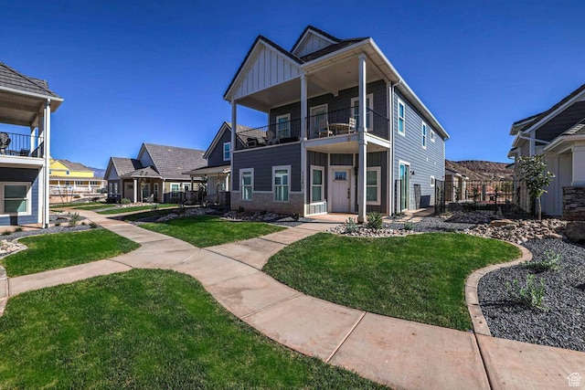 1240 E Villa Way Unit 64, Washington, UT 84780 - view of front of property with board and batten siding, a front yard, fence, and a balcony