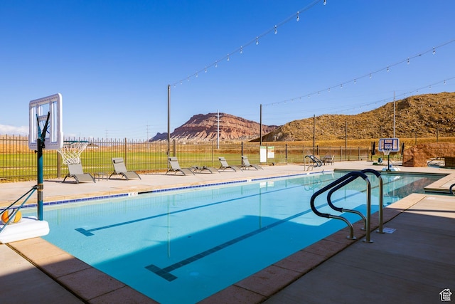 1240 E Villa Way Unit 64, Washington, UT 84780 - view of pool featuring a fenced in pool, a patio area, a mountain view, and fence