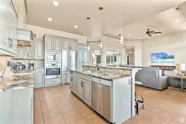 3193 S 4900 W, Hurricane, UT 84737 - kitchen with light tile patterned floors, stainless steel appliances, tasteful backsplash, open floor plan, and a sink